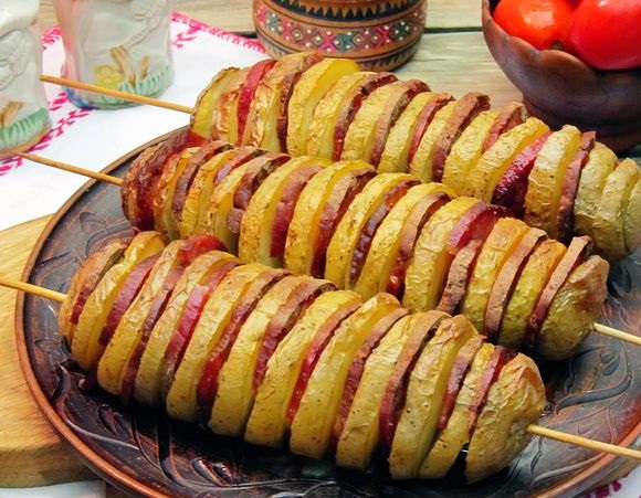 Spiral potatoes, baked with sausage, on skewers