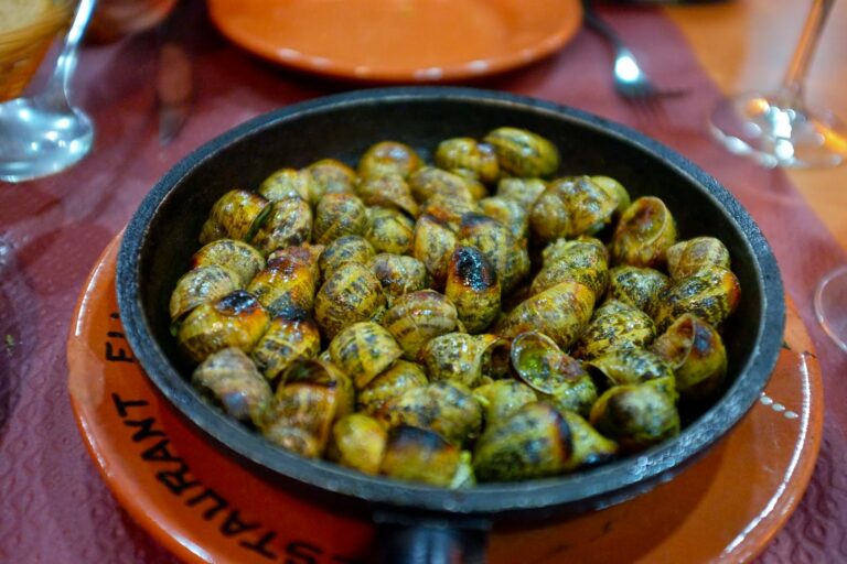 Are there any specific etiquette or customs associated with dining in Andorra?
