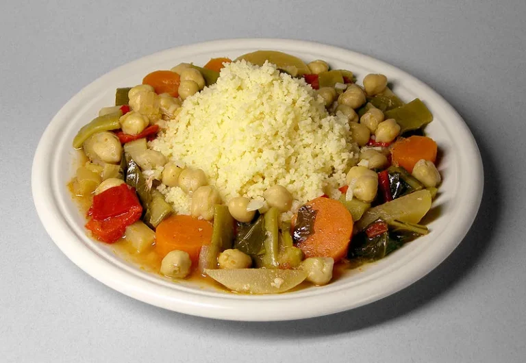 What are the staple ingredients used in Tunisian cooking?