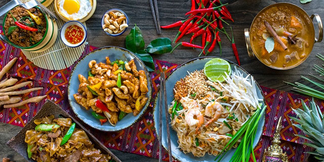 Are there any Thai dishes influenced by neighboring countries like Laos or Cambodia?