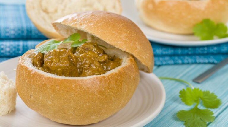 What are the key flavors and ingredients used in South African cuisine?