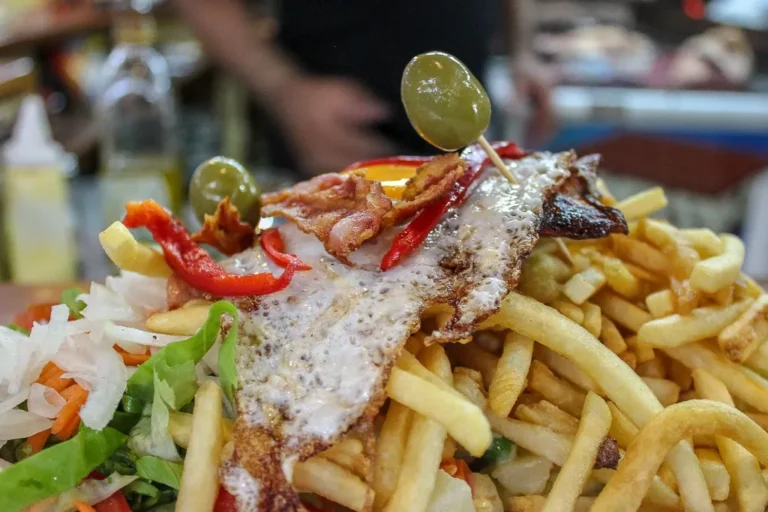 Are there any Uruguayan dishes influenced by neighboring countries like Argentina or Brazil?