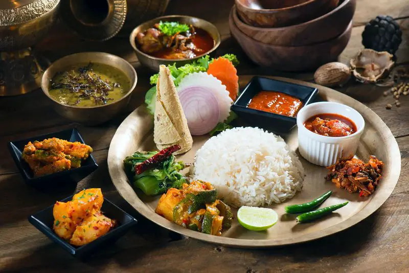Can you suggest some Nepalese dishes that are suitable for those with dietary restrictions, such as gluten-free or vegan options?