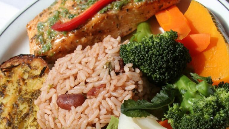 How is Antiguan and Barbudan cuisine influenced by neighboring countries?