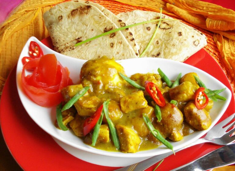 What is the significance of roti in Surinamese cuisine?