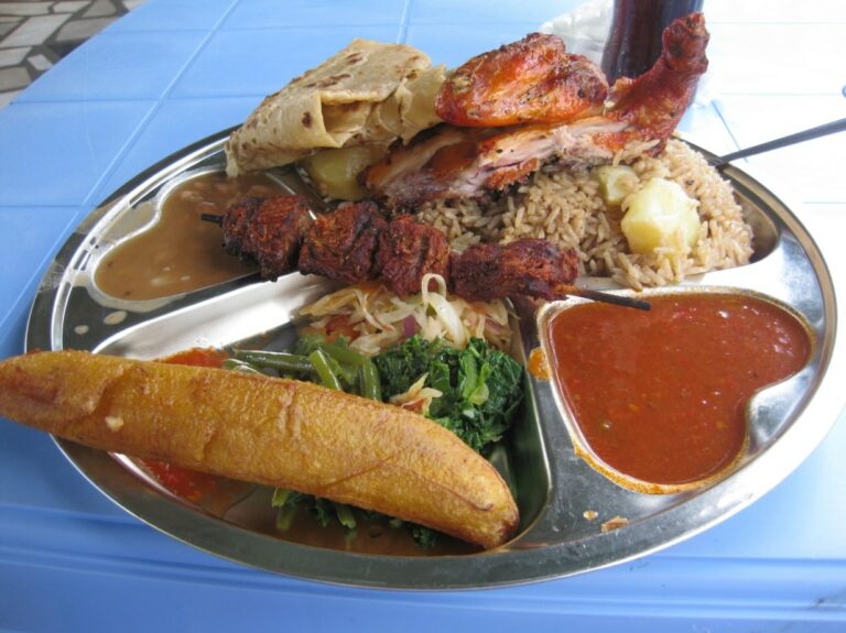 How is Tanzanian cuisine influenced by Indian and Arab flavors?