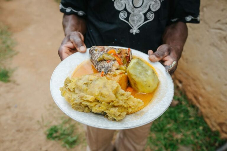 What is the significance of matooke (green bananas) in Ugandan cuisine?