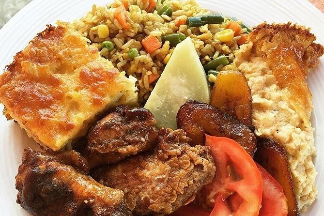 What is oil down, and why is it significant in Grenadian cuisine?