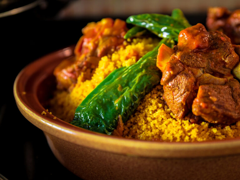 How is Tunisian cuisine influenced by Mediterranean and Arab flavors?