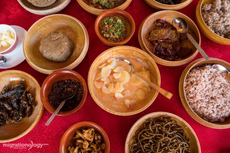 How is Bhutanese cuisine influenced by neighboring countries?