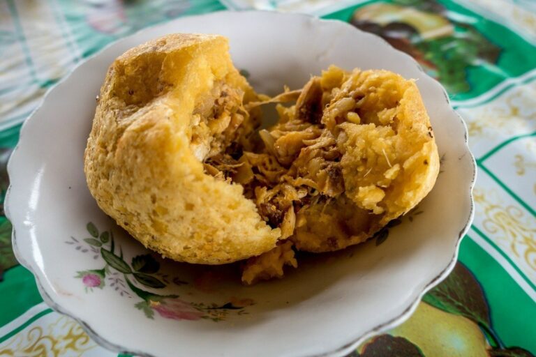 Can you explain the significance of “llapingachos,” a popular Ecuadorian dish made with mashed potatoes and cheese?