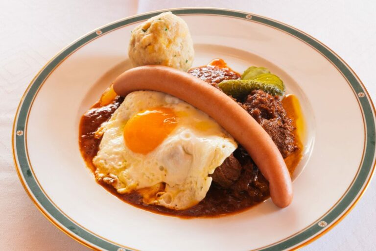 How is Austrian cuisine influenced by neighboring countries?