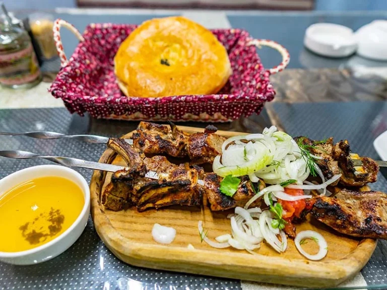 How does Tajik cuisine differ from other Central Asian cuisines?