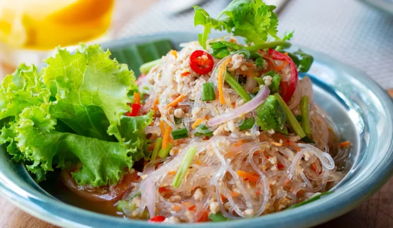 Are there any specific types of noodles or rice dishes associated with Laotian cuisine?