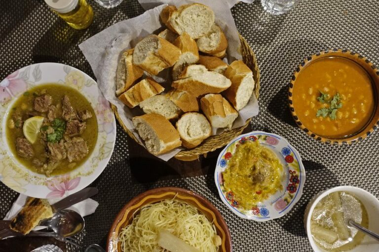 What are the staple ingredients in Algerian cuisine?