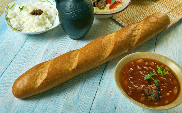 What are the staple ingredients in Gambian meals?