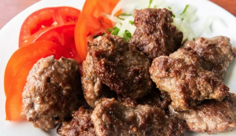 How is Albanian cuisine influenced by neighboring countries?