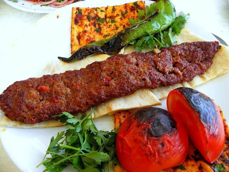 Can you find any influences from Kuwaiti modernization and international influences in the cuisine?
