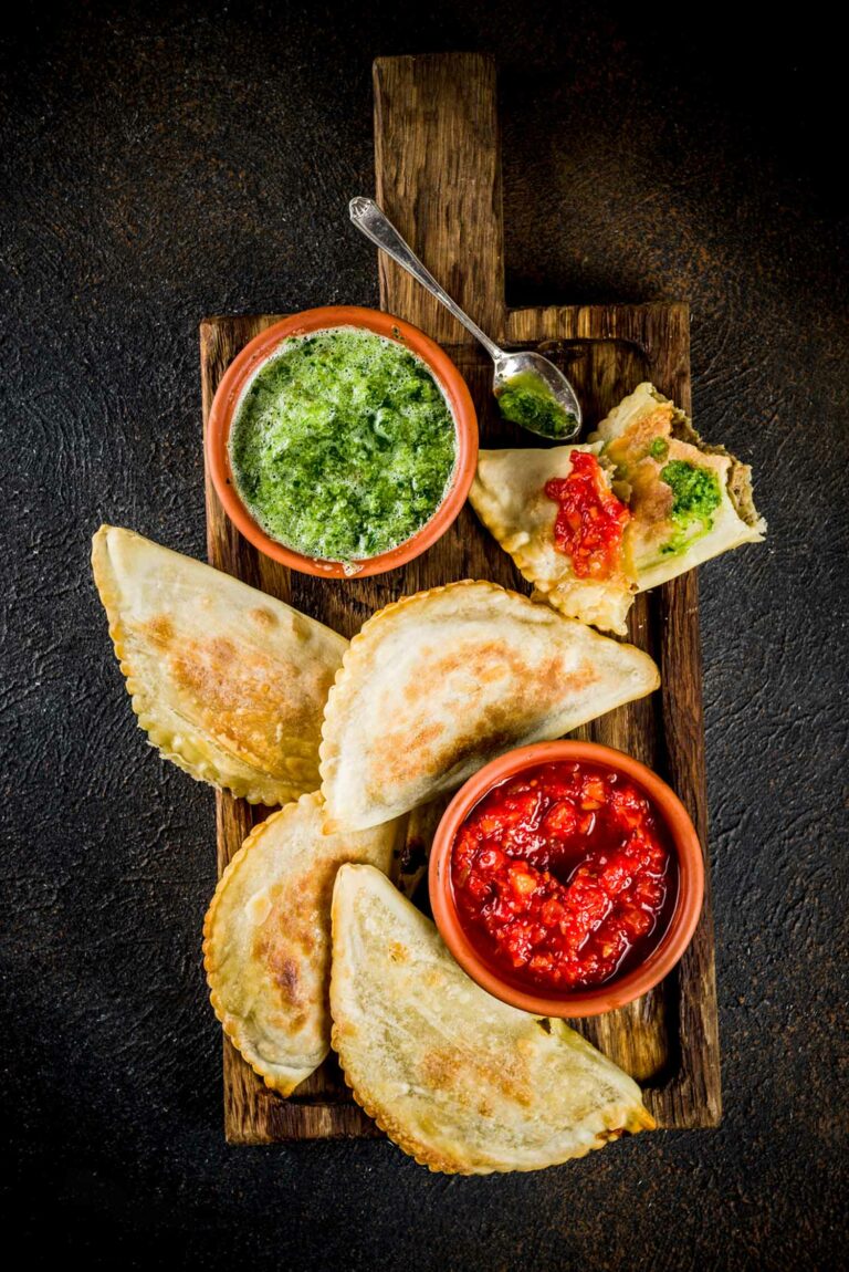 Can you tell me about the role of corn and potatoes in Chilean cuisine?