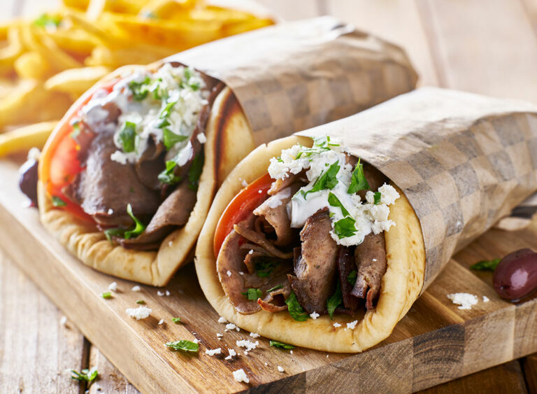 How can I find Greek restaurants or street food stalls in my area?