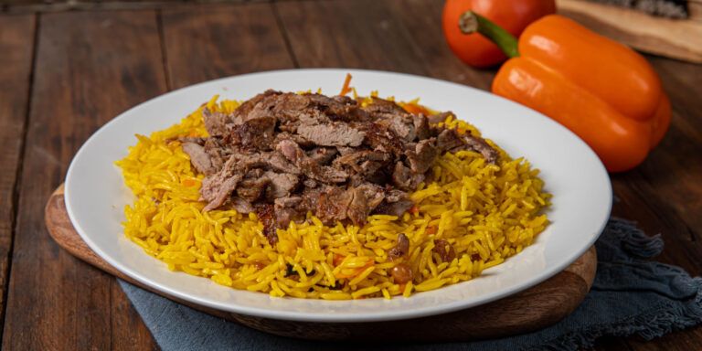 How has the country’s historical background and geographical location influenced Saudi Arabian cuisine?